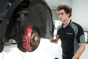 mechanic inspection a mercedes for a brake replacement package