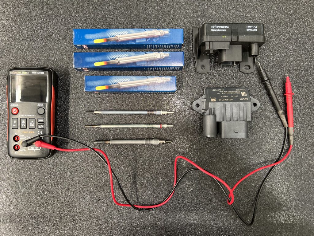 mercedes glow plug warning light and control unit relays and electrical multimeter on workbench