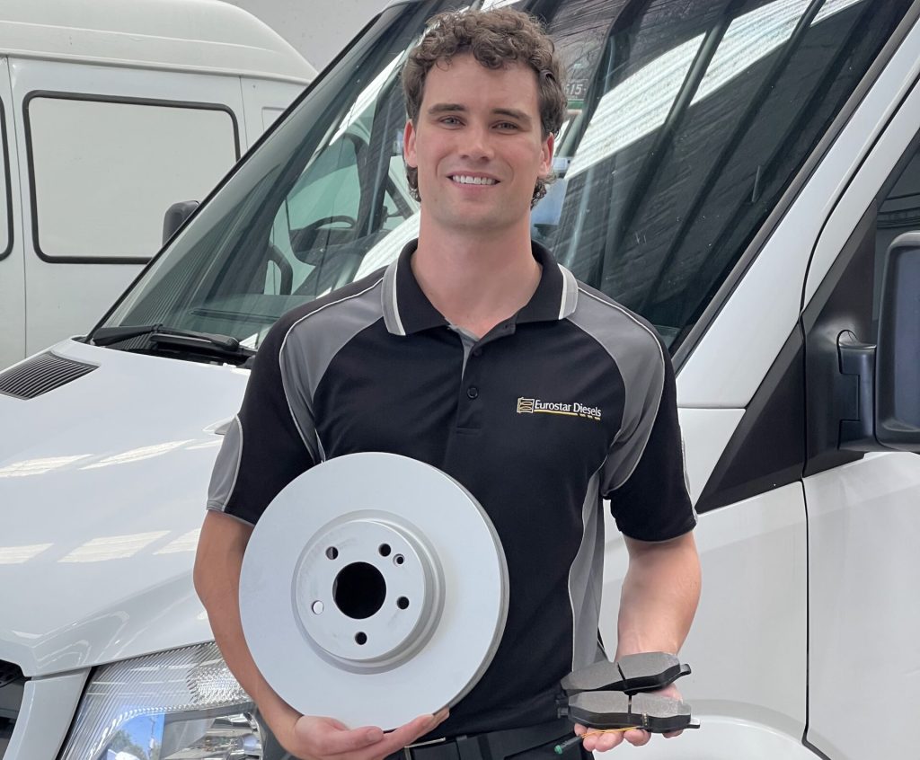 eurostar diesels technician holding brake components for a mercedes